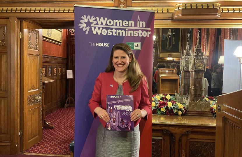 Theo Clarke MP holding her copy of Women in Westminster: The 100